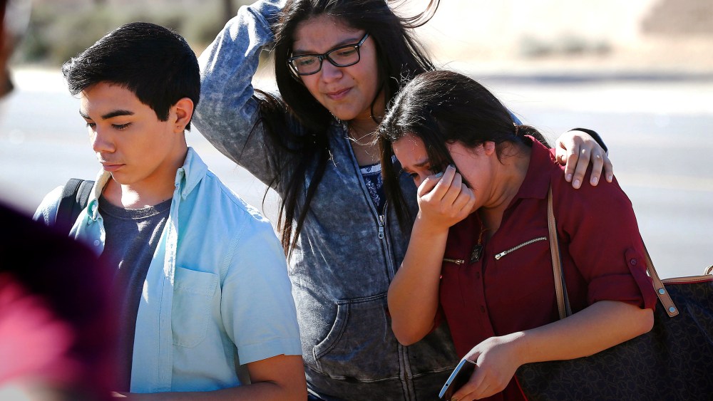 Students walk to their parents after being released from lockdown, Feb. 12, 2016, in Glendale, Ariz., after two students were shot and killed at Independence High School. (Photo by Matt York/AP)