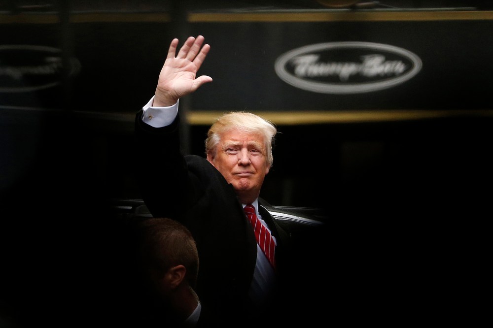Republican presidential candidate Donald Trump acknowledges supporters while leaving Trump Tower on his way to visit the World Trade Center Museum, April 9, 2016, in New York. (Photo by Julio Cortez/AP)