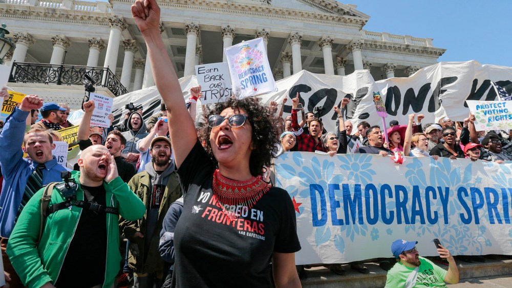 Alejandra Pablos of Arizona leads a chant as voting rights reform demonstrators stage a sit-in at the Capitol in Washington, April 11, 2016, urging lawmakers to take money out of the political process. (Photo by J. Scott Applewhite/AP)