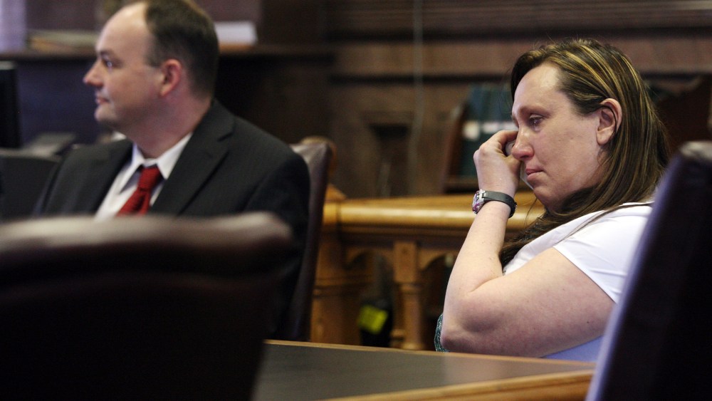 Kelli Jo Griffin, Montrose, Iowa, wipes away tears as she listens with her attorney to a not guilty verdict, March 20, 2014 in Keokuk, Iowa. (Photo by John Gaines/The Hawk Eye/AP)