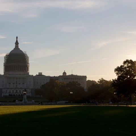 The sun rises behind the U.S. Capitol Building grounds in Washington, D.C., Oct. 20, 2014. (Photo by Carolyn Kaster/AP)