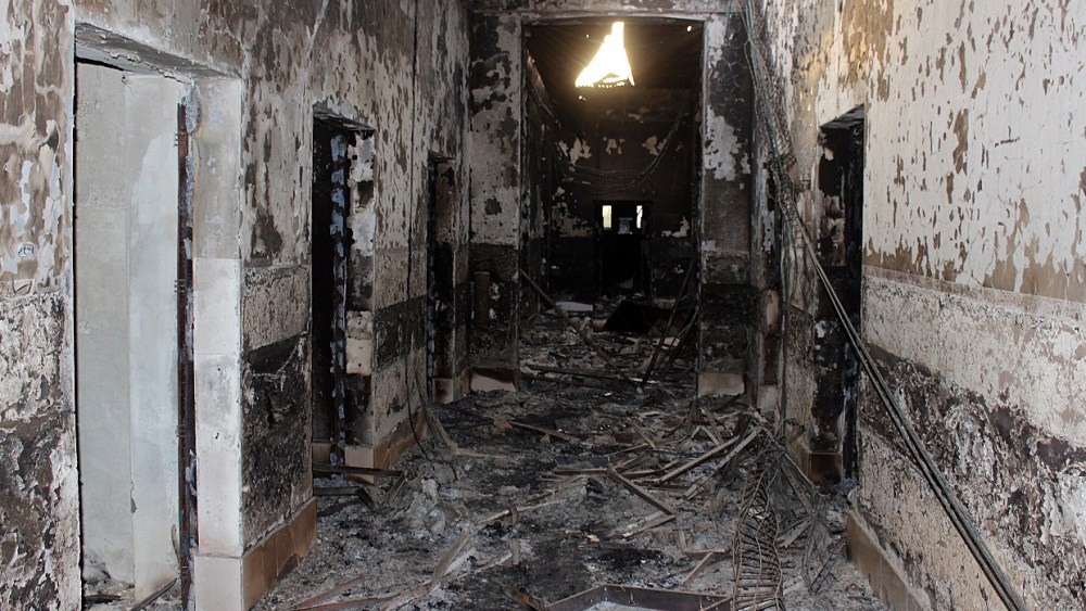 In this Friday, Oct. 16, 2015 photo, the charred remains of the Doctors Without Borders hospital is seen after being hit by a U.S. airstrike in Kunduz, Afghanistan. (Photo by Najim Rahim/AP)