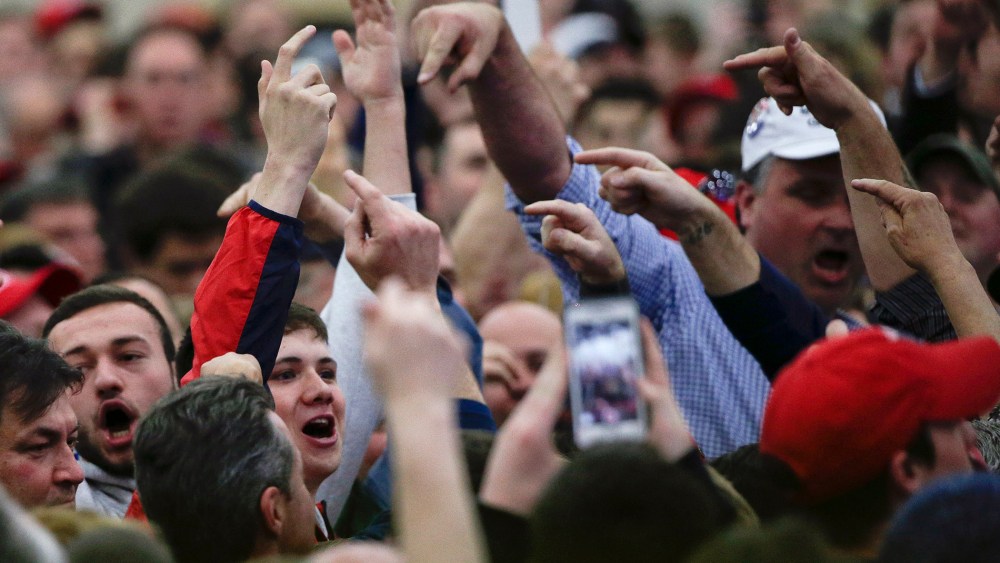 Supporters for Republican presidential candidate Donald Trump point out protestors before the start of a campaign rally, April 6, 2016, in Bethpage, N.Y. (Photo by Julie Jacobson/AP)