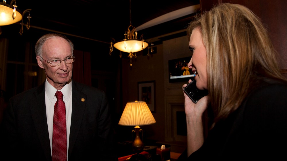 In this Tuesday, Nov. 4, 2014 file photo, Republican Gov. Robert Bentley listens to a phone call as Rebekah Mason, right, announces his win for Alabama governor, in Montgomery, Ala. (Photo by Brynn Anderson/AP)