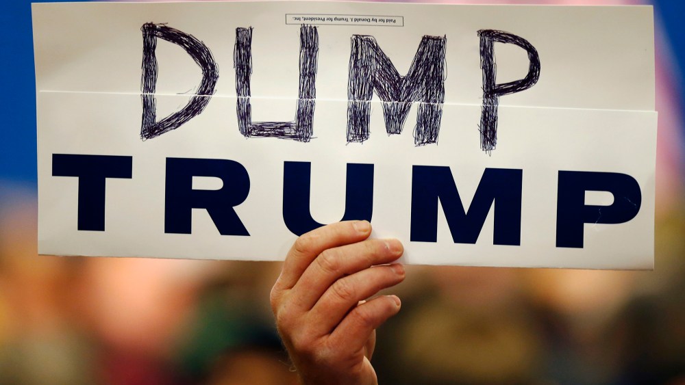 Walter Skold of Freeport, Maine, holds a "Dump Trump" sign at a campaign stop for the Republican presidential candidate, March 3, 2016, in Portland, Maine. (Photo by Robert F. Bukaty/AP)