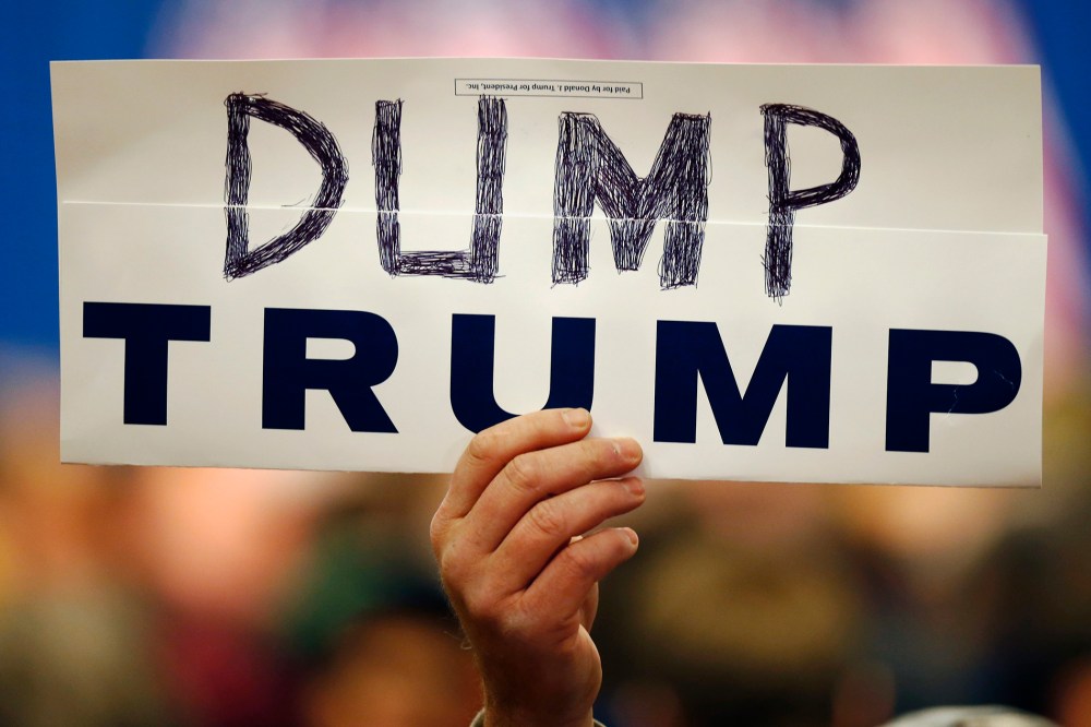 Walter Skold of Freeport, Maine, holds a "Dump Trump" sign at a campaign stop for the Republican presidential candidate, March 3, 2016, in Portland, Maine. (Photo by Robert F. Bukaty/AP)