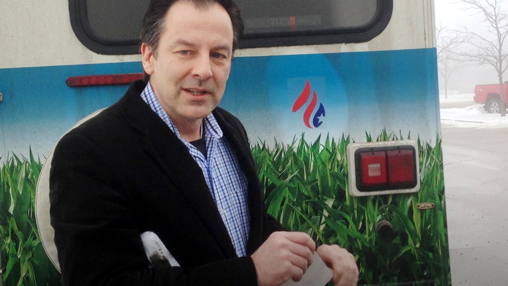 Rick Tyler, communications director for Sen. Ted Cruz, R-Texas presidential campaign, speaks speaks after affixing a Cruz sticker on an RV of a group that is openly critical of Cruz, Jan. 7, 2015, in Storm Lake, Iowa. (Photo by Scott Bauer/AP)