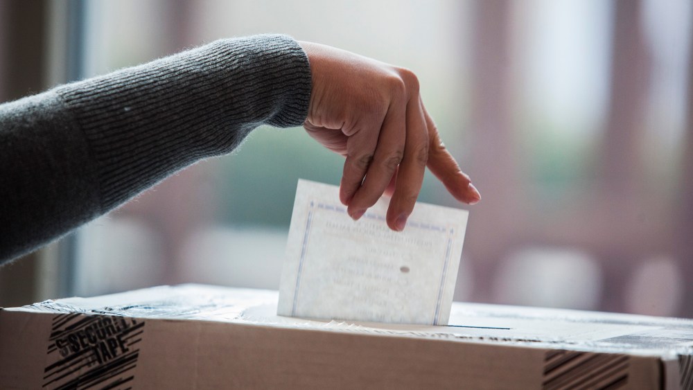 A woman places her vote into the ballot box on March 5, 2016 in Bowling Green, Ky. (Photo by Austin Anthony/Daily News/AP)