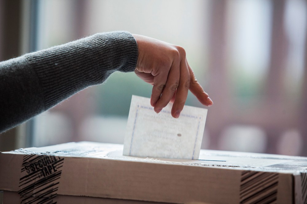 A woman places her vote into the ballot box on March 5, 2016 in Bowling Green, Ky. (Photo by Austin Anthony/Daily News/AP)