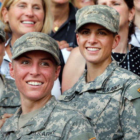 In this Aug. 21, 2015, file photo, Army 1st Lt. Shaye Haver, center, and Capt. Kristen Griest, right, pose for photos with other female West Point alumni after an Army Ranger school graduation ceremony at Fort Benning, Ga. (Photo by John Bazemore/AP)