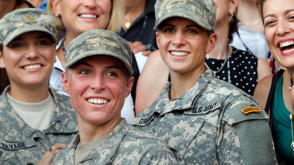 In this Aug. 21, 2015, file photo, Army 1st Lt. Shaye Haver, center, and Capt. Kristen Griest, right, pose for photos with other female West Point alumni after an Army Ranger school graduation ceremony at Fort Benning, Ga. (Photo by John Bazemore/AP)
