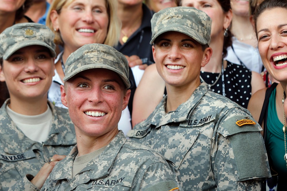 In this Aug. 21, 2015, file photo, Army 1st Lt. Shaye Haver, center, and Capt. Kristen Griest, right, pose for photos with other female West Point alumni after an Army Ranger school graduation ceremony at Fort Benning, Ga. (Photo by John Bazemore/AP)