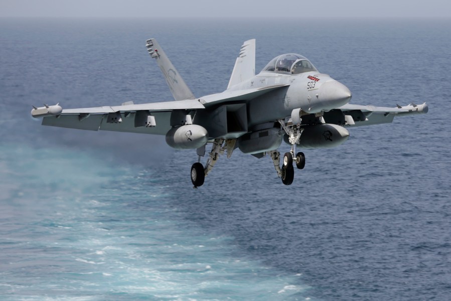 A U.S. military plane approaches to land on the flight deck of the USS Carl Vinson aircraft carrier in the Persian Gulf on March 19, 2015. (Photo by Hasan Jamali/AP)