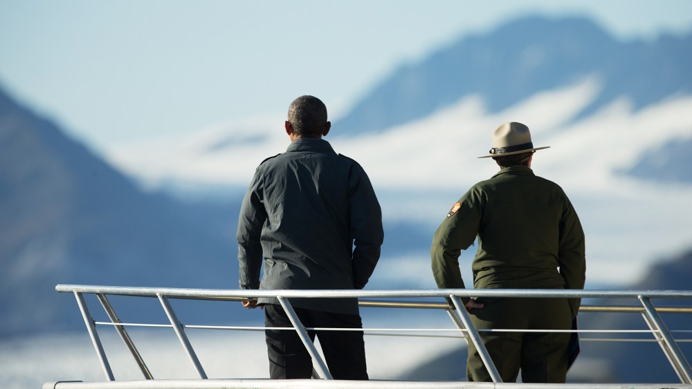 President Barack Obama and a National Park Service employee look at Bear Glacier, which has receded 1.8 miles in approximately 100 years, Tuesday, Sept. 1, 2015, in Seward, Alaska. (Photo by Andrew Harnik/AP)