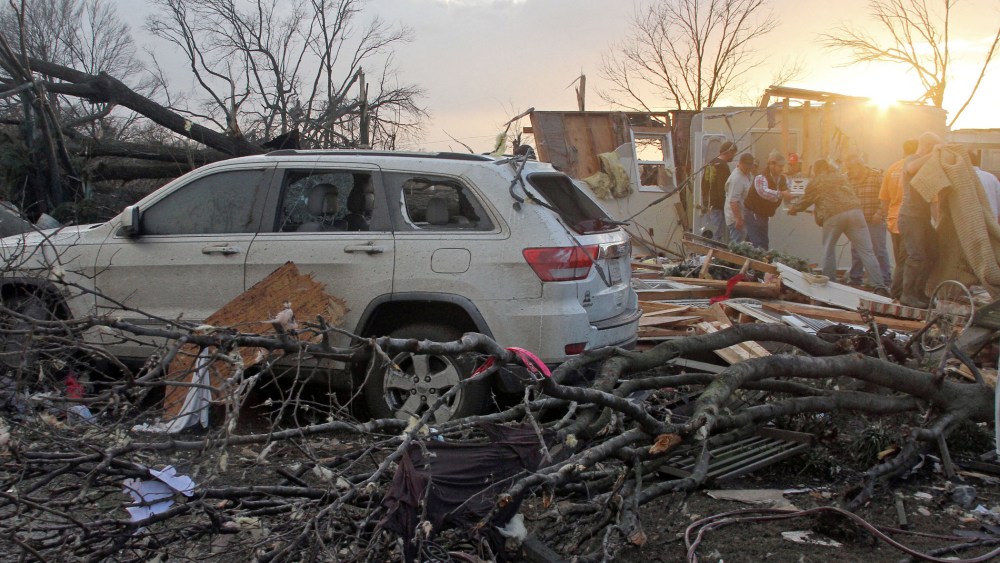 Neighbors help salvage items from a storm-damaged home in the Roundaway community near Clarksdale, Miss., Dec. 23, 2015. (Photo by Troy Catchings/The Press Register/AP)