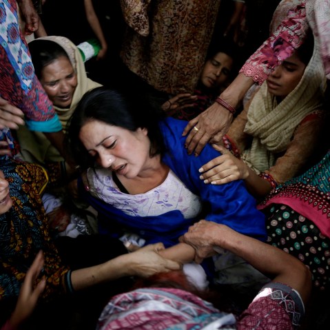 Women try to comfort a mother who lost her son in bomb attack in Lahore, Pakistan, March 28, 2016. (Photo by K.M. Chaudary/AP)