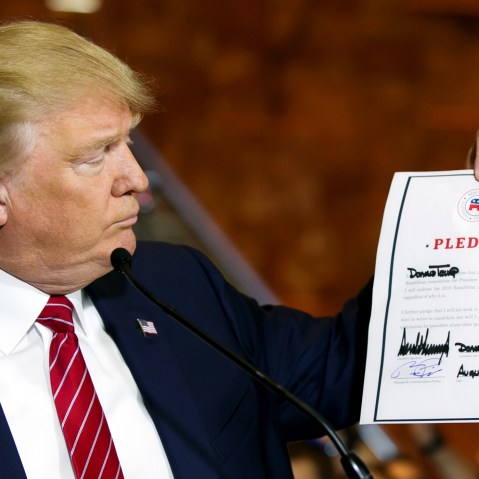 Republican presidential candidate Donald Trump looks at a signed pledge during a news conference in Trump Tower, Thursday, Sept. 3, 2015 in New York. (Photo Richard Drew/AP)