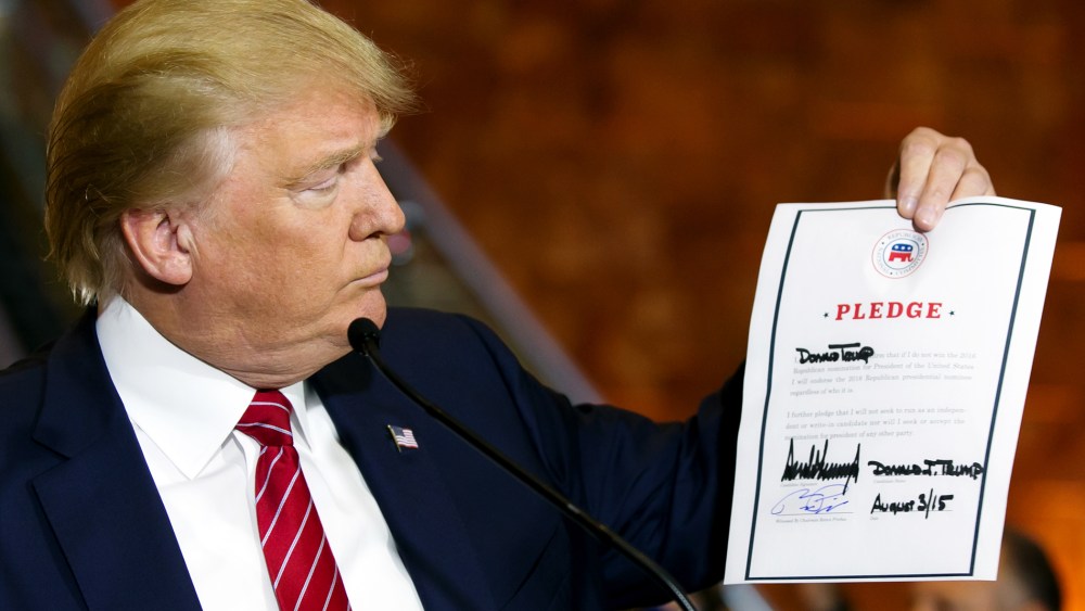 Republican presidential candidate Donald Trump looks at a signed pledge during a news conference in Trump Tower, Thursday, Sept. 3, 2015 in New York. (Photo Richard Drew/AP)