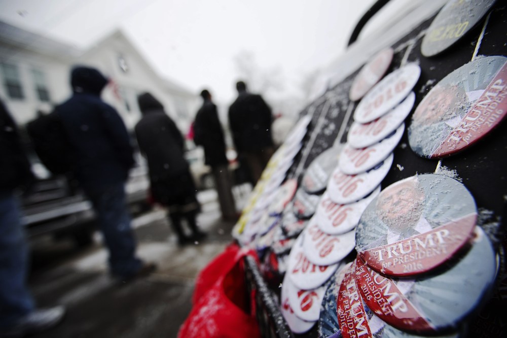 Snow collects on buttons for sale outside a campaign event for Republican presidential candidate Donald Trump at the Londonderry Lions Club, Feb. 8, 2016, in Londonderry, N.H. (Photo by David Goldman/AP)