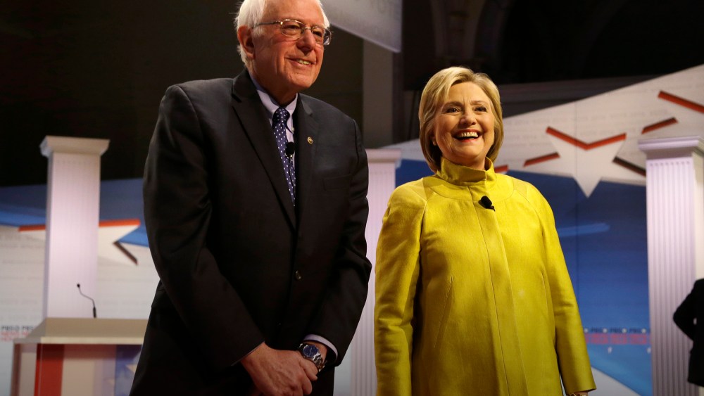 Democratic presidential candidates Sen. Bernie Sanders and Hillary Clinton smile as they take the stage before a Democratic debate, Feb. 11, 2016, in Milwaukee, Wis. (Photo by Tom Lynn/AP)