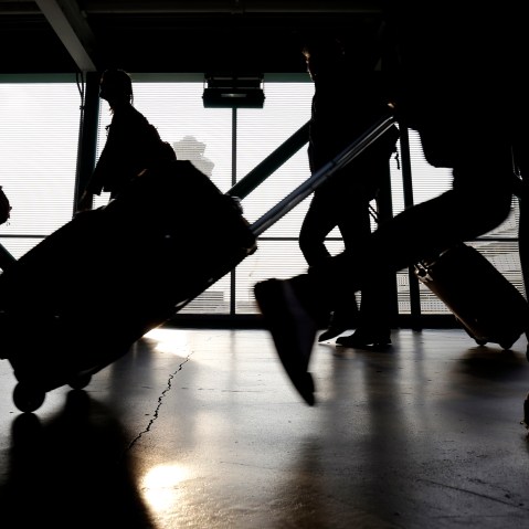 Travelers walk through O'Hare International airport in Chicago, Ill. (Photo by Nam Y. Huh/AP)