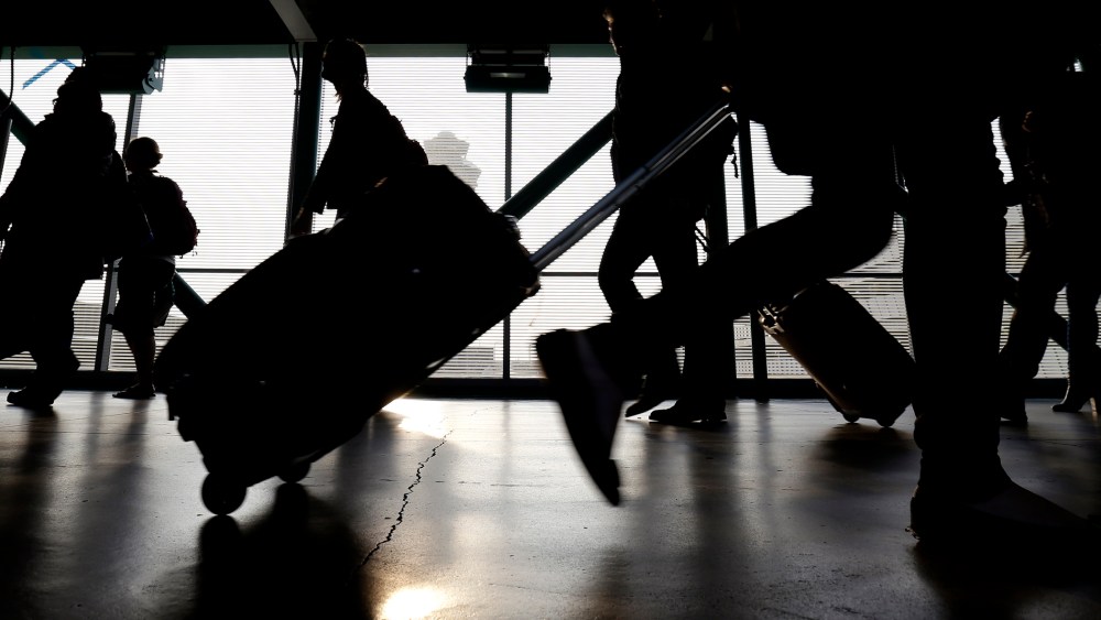 Travelers walk through O'Hare International airport in Chicago, Ill. (Photo by Nam Y. Huh/AP)