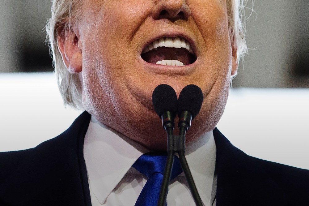 Republican presidential candidate Donald Trump bares his teeth during a campaign stop at the Signature Flight Hangar at Port-Columbus International Airport, March 1, 2016, in Columbus, Ohio. (Photo by John Minchillo/AP)
