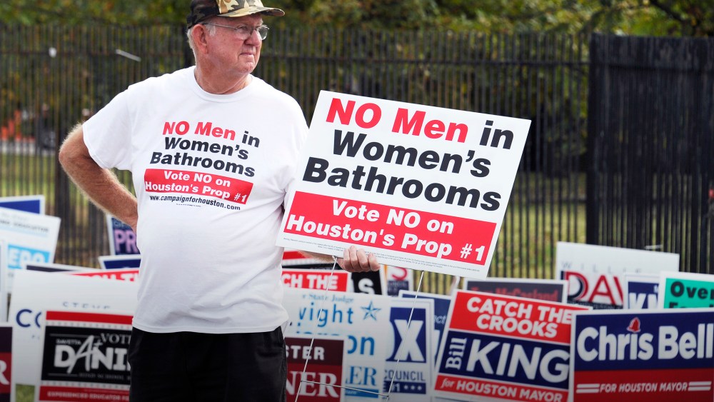 In this Oct. 21, 2015 file photo, a man urges people to vote against the Houston Equal Rights Ordinance outside an early voting center in Houston. (Photo by Pat Sullivan/AP)