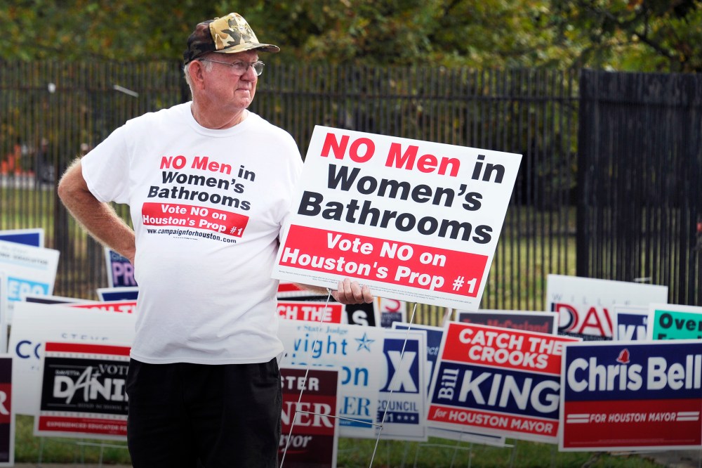 In this Oct. 21, 2015 file photo, a man urges people to vote against the Houston Equal Rights Ordinance outside an early voting center in Houston. (Photo by Pat Sullivan/AP)