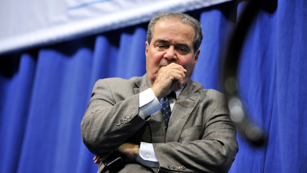Supreme Court Justice Antonin Scalia stands at the edge of the stage after a question and answer session on Oct. 2, 2013, in Medford, Mass. (Photo by Josh Reynolds/AP)