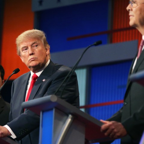 Republican presidential candidate Donald Trump looks toward Jeb Bush, right, as Scott Walker watches during the first Republican presidential debate at the Quicken Loans Arena on Aug. 6, 2015, in Cleveland, Ohio. (Photo by Andrew Harnik/AP)
