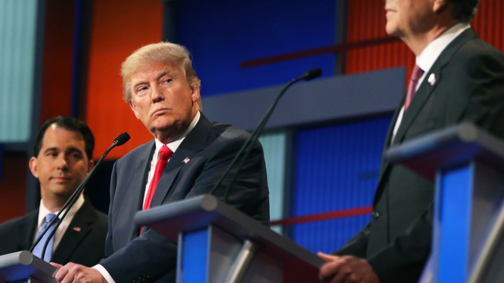 Republican presidential candidate Donald Trump looks toward Jeb Bush, right, as Scott Walker watches during the first Republican presidential debate at the Quicken Loans Arena on Aug. 6, 2015, in Cleveland, Ohio. (Photo by Andrew Harnik/AP)