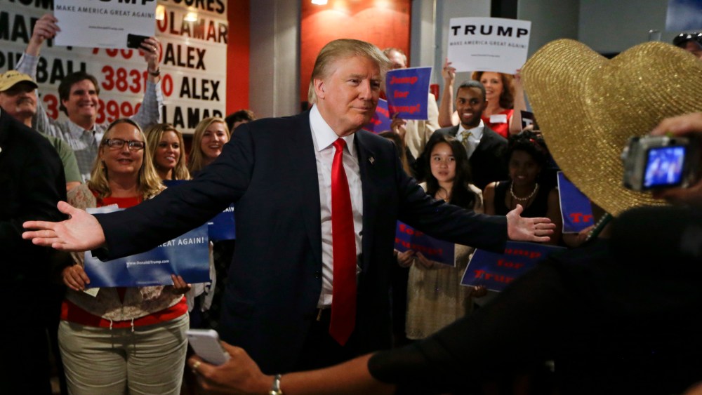 Republican presidential candidate Donald Trump reaches out to hug a supporter after he spoke at the National Federation of Republican Assemblies on Aug. 29, 2015, in Nashville, Tenn. (Photo by Mark Humphrey/AP)