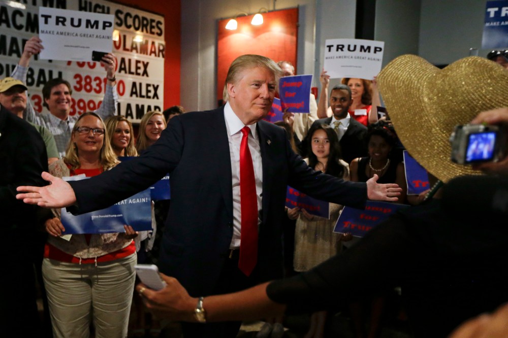 Republican presidential candidate Donald Trump reaches out to hug a supporter after he spoke at the National Federation of Republican Assemblies on Aug. 29, 2015, in Nashville, Tenn. (Photo by Mark Humphrey/AP)