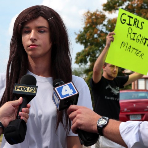 Lila Perry, a Hillsboro High School senior and transgender student, speaks with reporters as Blayke Childs, back, offers his opinion on Aug. 31, 2015. (Photo by Robert Cohen/St. Louis Post/Dispatch/AP)