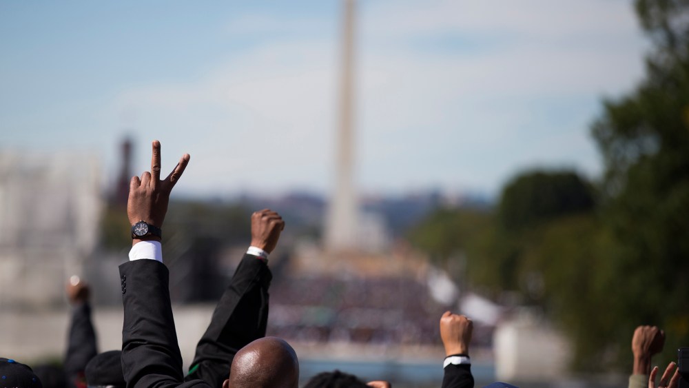 People put their hands in the air during a rally to mark the 20th anniversary of the Million Man March, on Capitol Hill, on Oct. 10, 2015, in Washington. (Photo by Evan Vucci/AP)