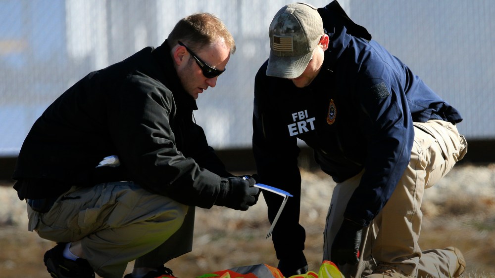 FBI agents look at evidence along Hesston Road outside Excel Industries in Hesston, Kan., Feb. 26, 2016. (Photo by Orlin Wagner/AP)