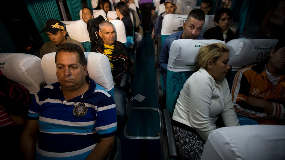 Cuban migrants wait on a bus in Ciudad Pedro De Alvarado, Guatemala, at the border with El Salvador, Jan. 13, 2016, as they continue on their journey to the United States. (Photo by Moises Castillo/AP)