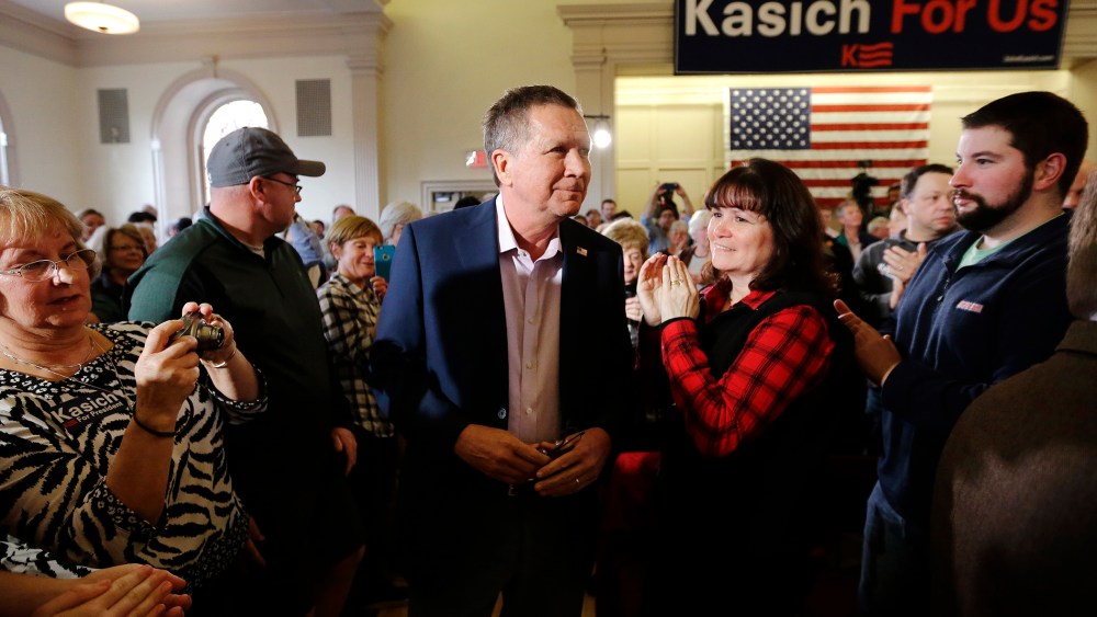 Republican presidential candidate, Ohio Gov. John Kasich, center, arrives at the start of a town hall campaign event, Feb. 29, 2016, in Plymouth, Mass. (Photo by Steven Senne/AP)