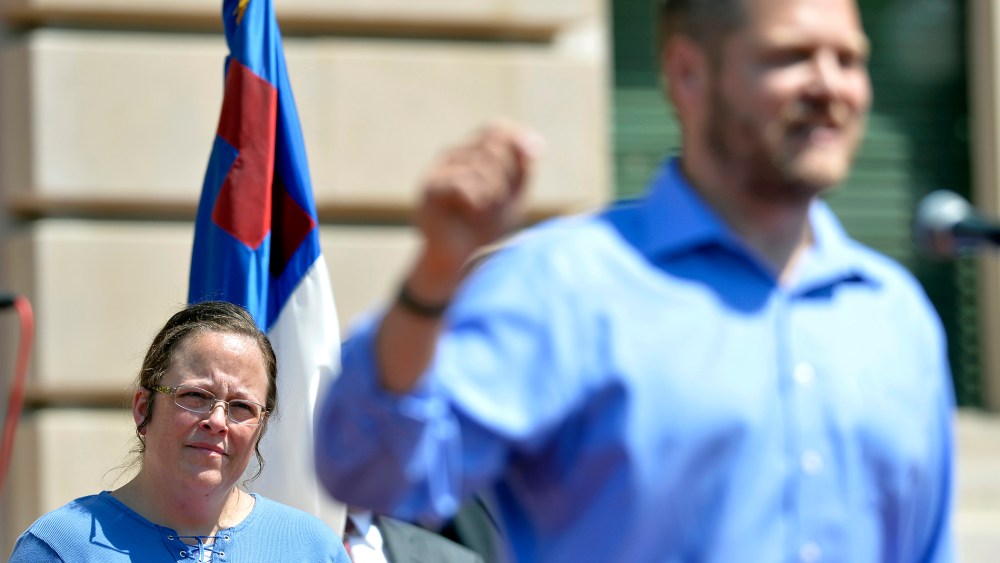Rowan County Clerk Kim Davis, left, listens as Casey County Clerk Casey Davis speaks to a group of supporters during a rally at the Kentucky State Capitol in Frankfort Ky., Saturday, Aug. 22, 2015. (Photo by Timothy D. Easley/AP)