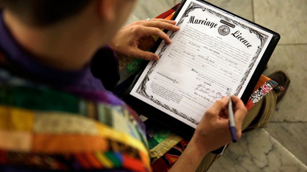 In this Nov. 5, 2014 file photo, a Missouri marriage license is signed after a same sex marriage ceremony in St. Louis, Mo. (Photo by Jeff Roberson/AP)