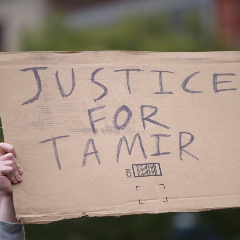 A "Justice for Tamir" sign is held aloft on Nov. 22, 2015. (Photo by Andy Katz/Pacific Press/Sipa/AP)