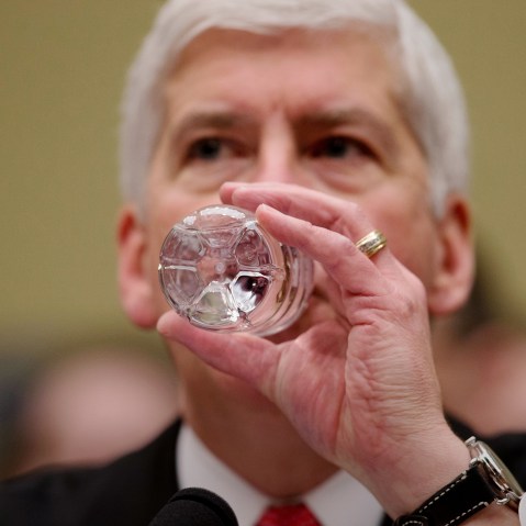 Michigan Gov. Rick Snyder drinks water as he testifies before a House Oversight and Government Reform Committee hearing in Washington, March 17, 2016. (Photo by Andrew Harnik/AP)