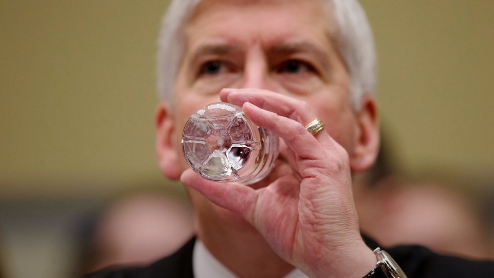 Michigan Gov. Rick Snyder drinks water as he testifies before a House Oversight and Government Reform Committee hearing in Washington, March 17, 2016. (Photo by Andrew Harnik/AP)