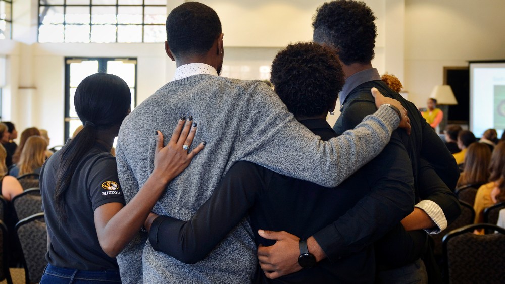 In this Saturday, Nov. 7, 2015, photo, members of an anti-racism and black awareness group embrace during a protest in the University of Missouri campus in Columbia, Mo. (Photo by Ellise Verheyen/Missourian/AP)