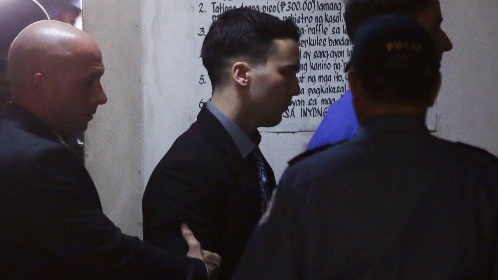 U.S. Marine Lance Cpl. Joseph Scott Pemberton, center, is escorted inside a court in Olongapo city, Philippines on Dec. 1, 2015. (Photo by Aaron Favila/AP)