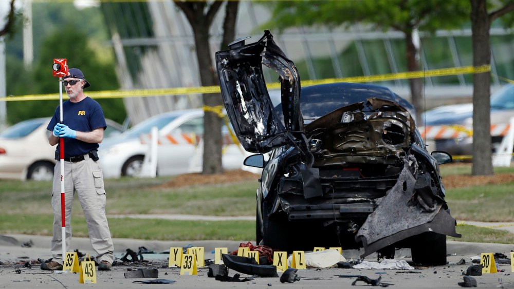 In this May 4, 2015 file photo, FBI crime scene investigators document evidence outside the Curtis Culwell Center in Garland, Texas. (Photo by Brandon Wade/AP)