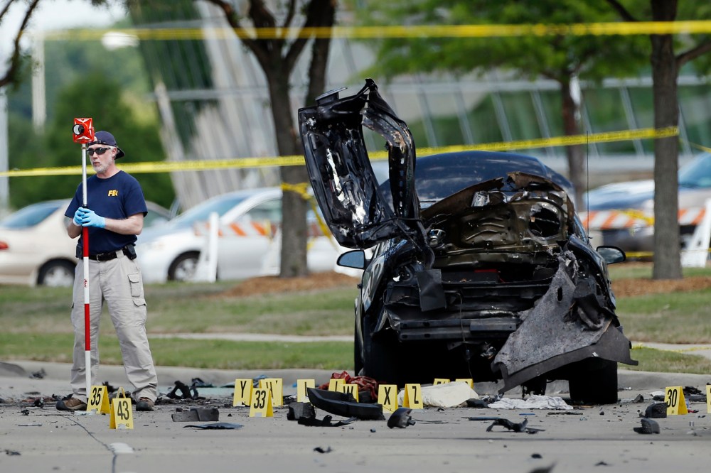 In this May 4, 2015 file photo, FBI crime scene investigators document evidence outside the Curtis Culwell Center in Garland, Texas. (Photo by Brandon Wade/AP)