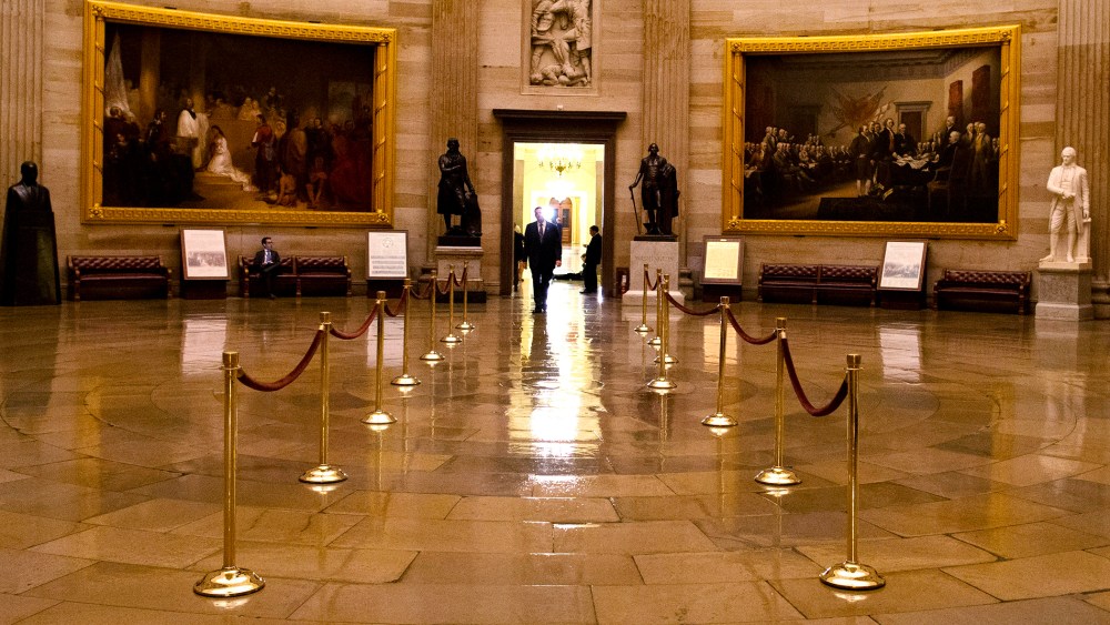 A man walks through a nearly empty Capitol Rotunda on Capitol Hill in Washington. (Photo by Evan Vucci/AP)