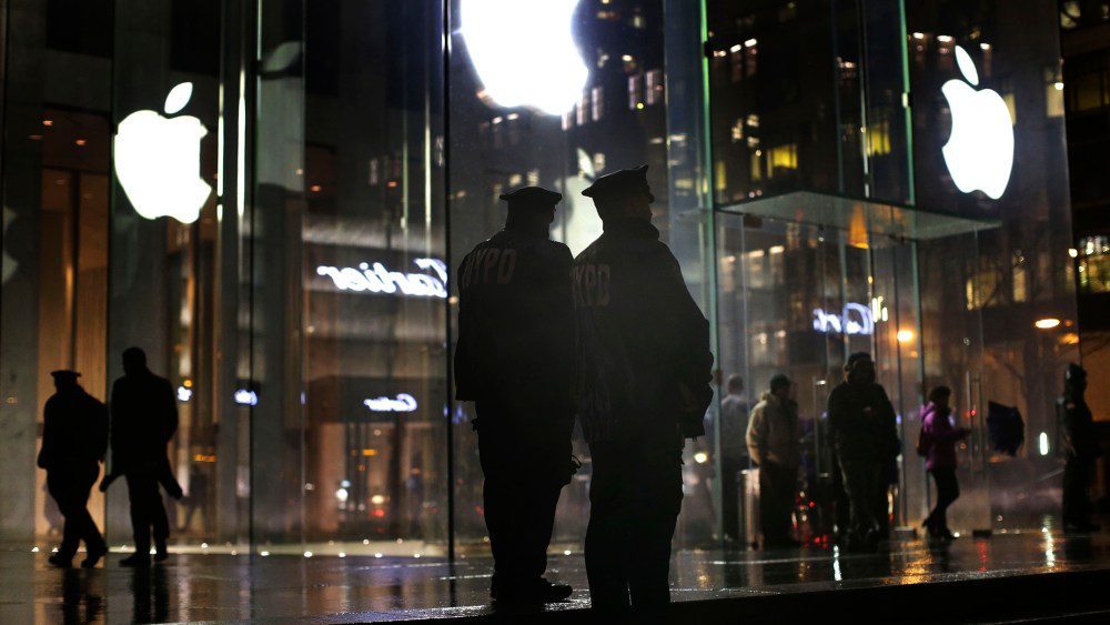 New York police officers stand outside the Apple Store on Fifth Avenue while monitoring a demonstration, Feb. 23, 2016, in New York. (Photo by Julie Jacobson/AP)